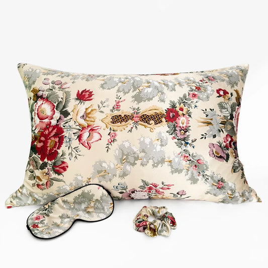Floral-patterned pillow, eye mask, and scrunchie on a white background