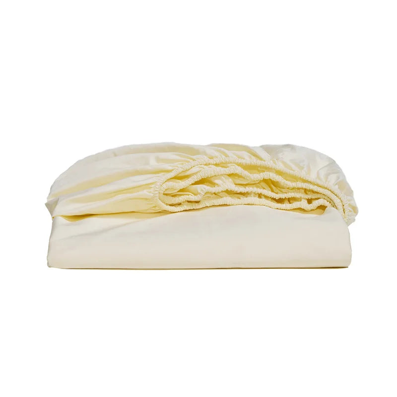Folded cream-colored blanket on a white background