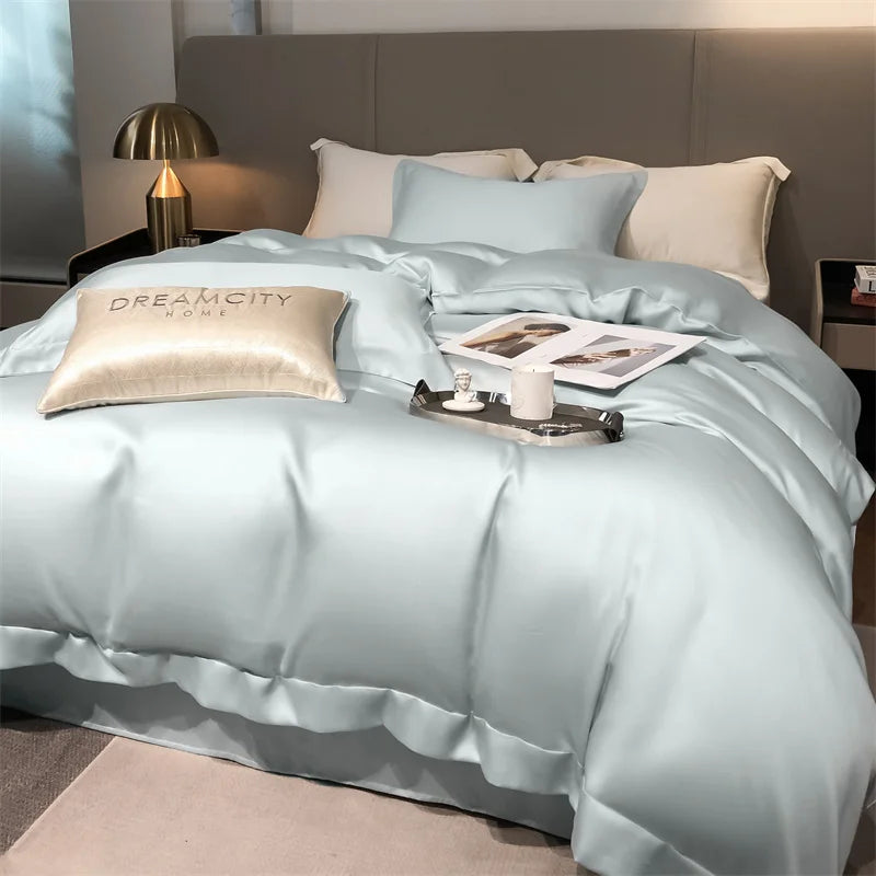 Light blue bedding set on a bed with pillows and a tray in a bedroom setting.