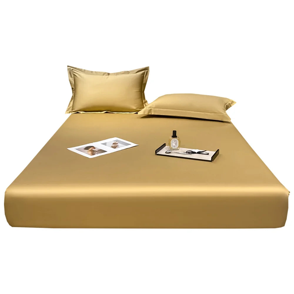 Gold satin bed sheet set with pillowcases on a white background