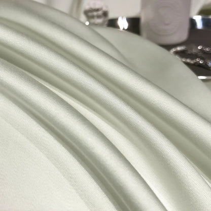 Close-up of light green fabric with a blurred background