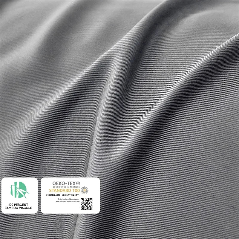 Gray fabric with OEKO-TEX and Standard 100 labels on a gray background