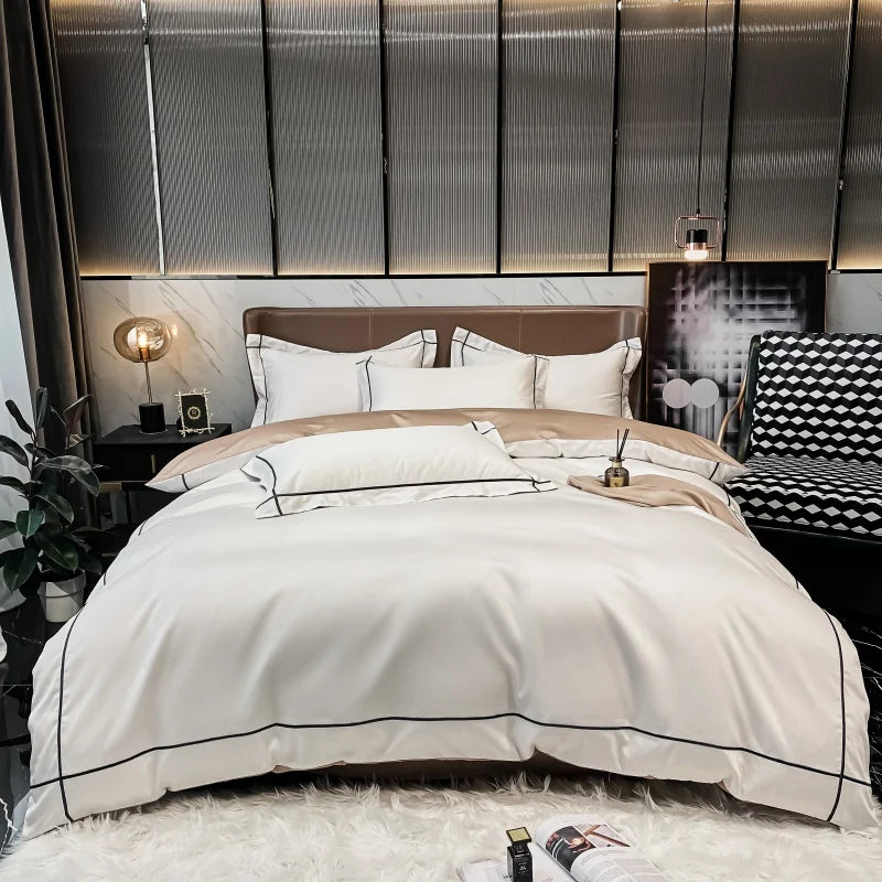 Neatly made bed with white bedding in a modern bedroom setting.