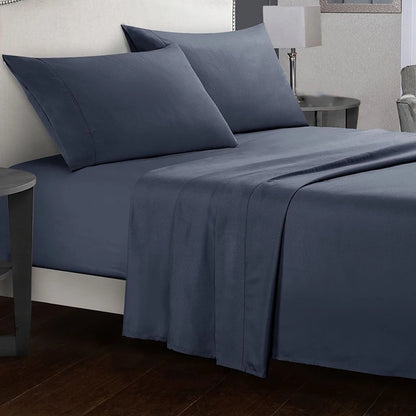 Blue bed sheets and pillows on a bed in a bedroom setting.