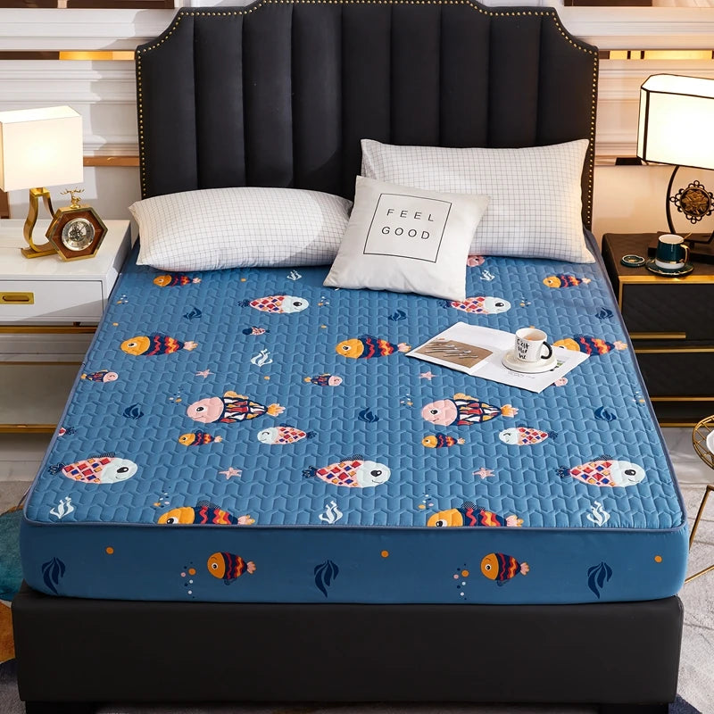 Bed with a blue mattress cover featuring cartoon fish design, in a bedroom setting.