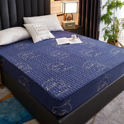 Blue mattress cover with animal patterns on a bed in a bedroom setting.