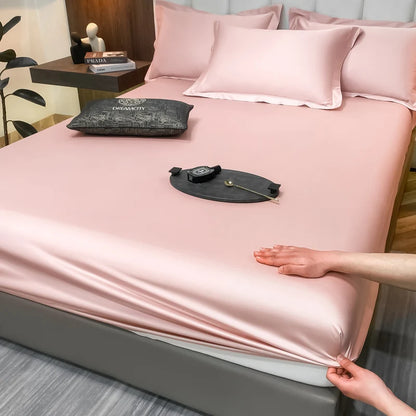 Person touching a pink satin sheet on a bed with a Prada bag in the background.