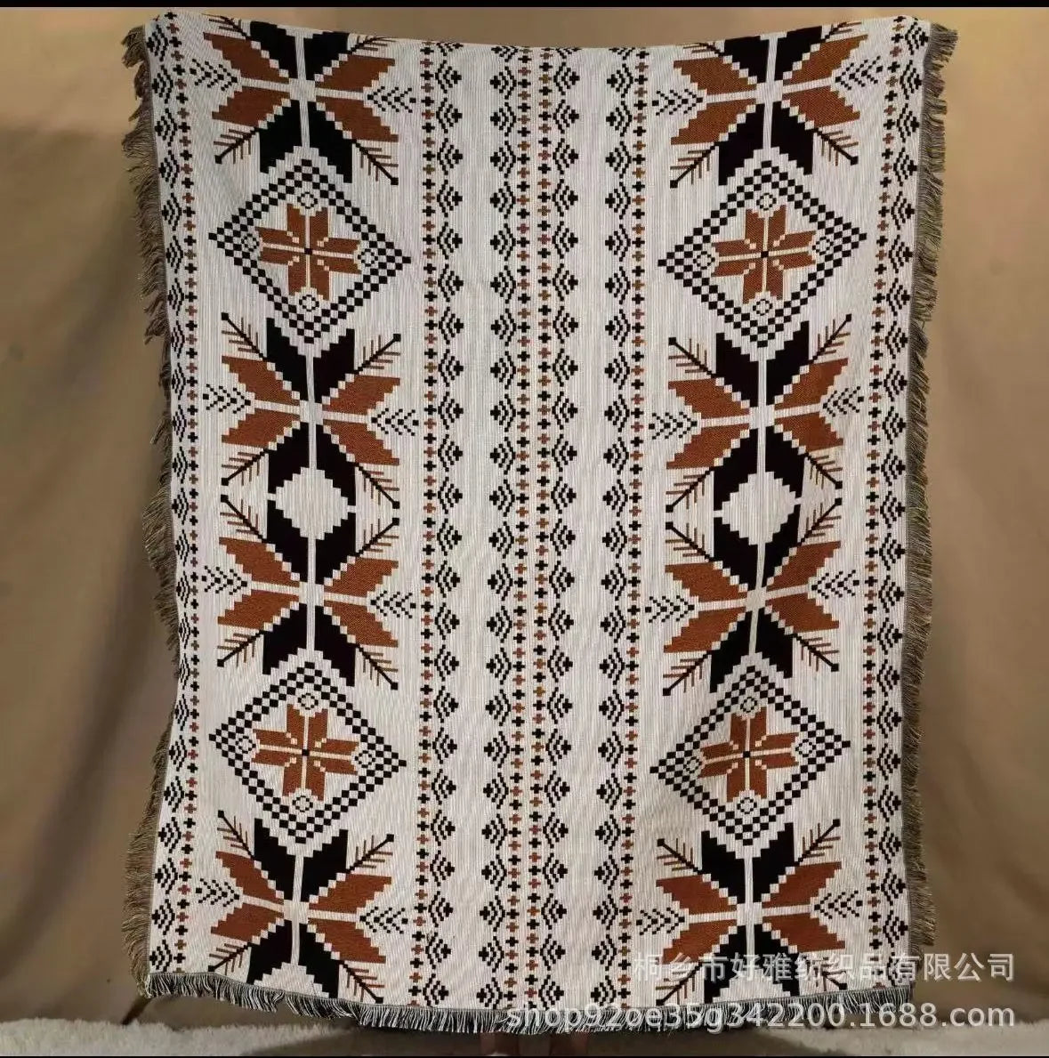 Patterned blanket with geometric design on a beige background