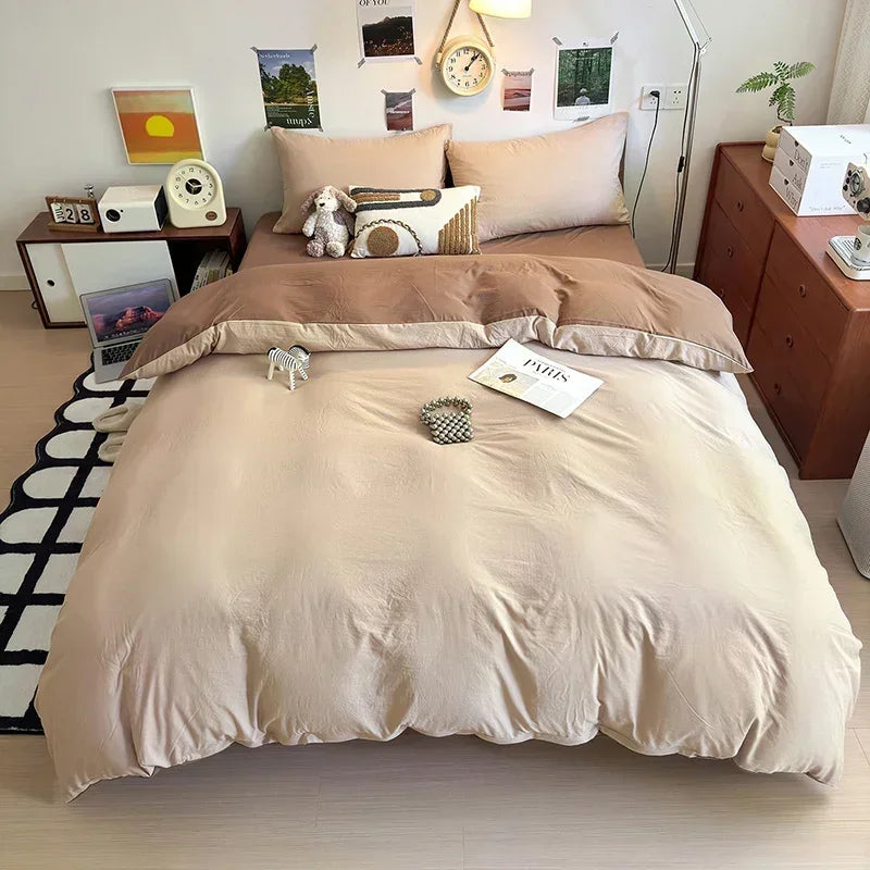 Beige bedding set on a bed in a room with wooden furniture and decor.
