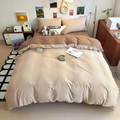 Beige bedding set on a bed in a room with wooden furniture and decor.