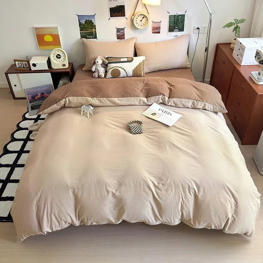 Beige bedding set on a bed in a room with wooden furniture and decor.