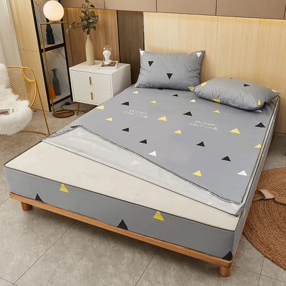 Gray mattress cover with geometric pattern on a bed in a bedroom setting
