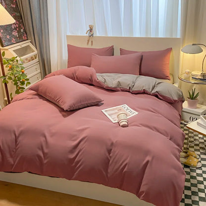 Pink bedding set on a bed in a bedroom with decor elements.