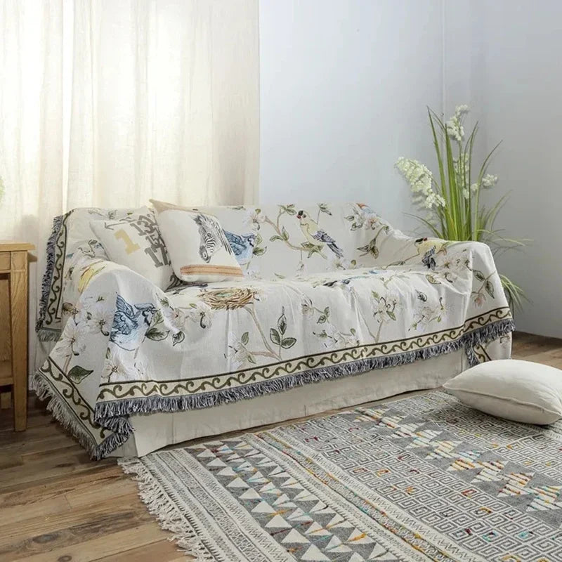 Sofa with floral patterned cover in a room with a rug and plant
