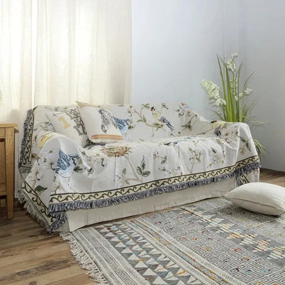 Sofa with floral patterned cover in a room with a rug and plant