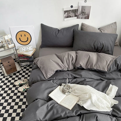 Gray bedding set on a bed with a checkered floor and wall decorations.