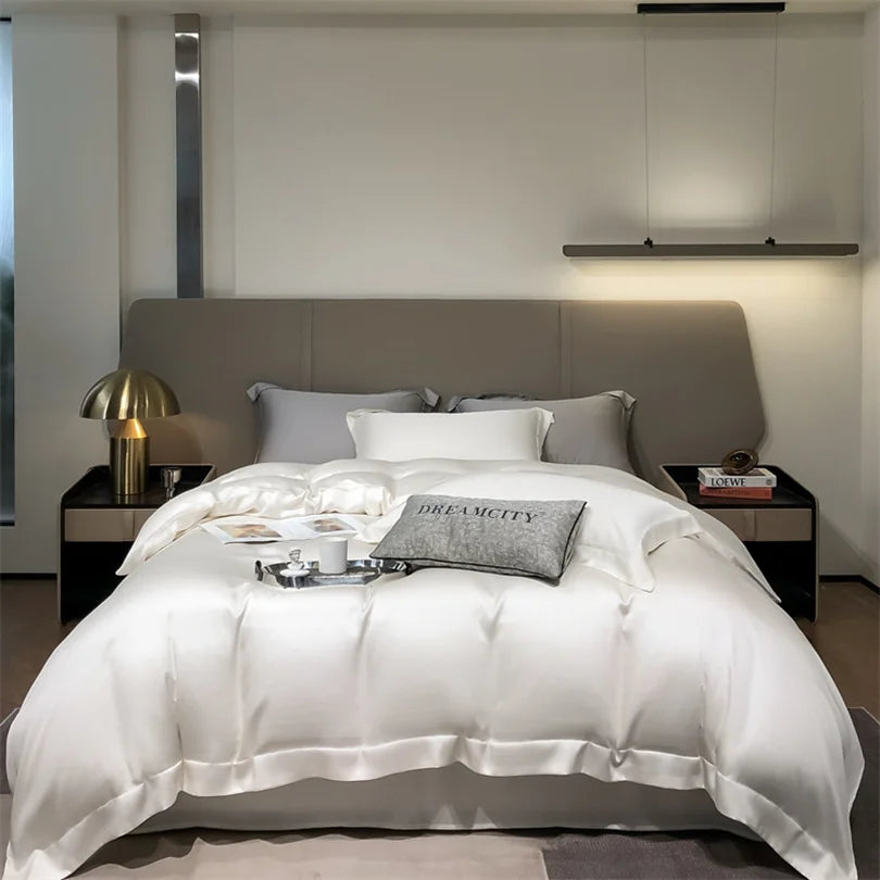 Modern bedroom with a bed featuring white bedding and decorative pillows.