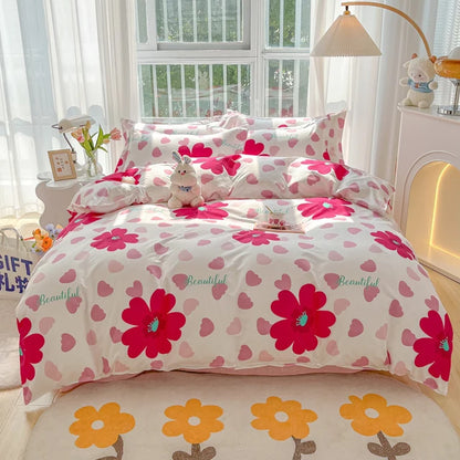 Floral bedding set with pink flowers and hearts on a bed in a bright room.