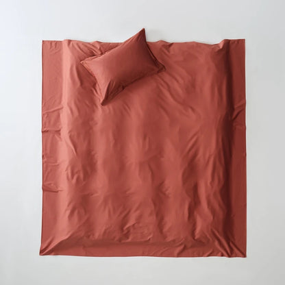 Reddish-brown bedding set with a pillow on a white background
