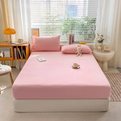 Bed with pink bedding in a bright room with a window and decor items.