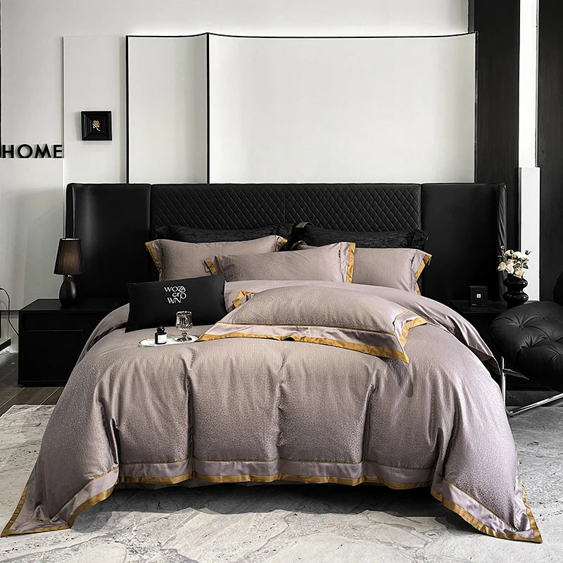 Modern bedroom with a bed featuring gray bedding and black headboard.