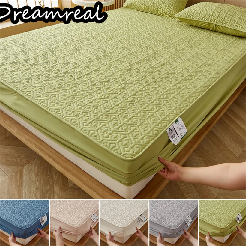 Green mattress cover on a bed with 'Dreamreal' branding, showing different color options.