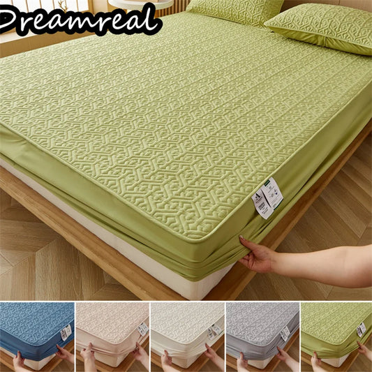 Green mattress cover on a bed with 'Dreamreal' branding, showing different color options.
