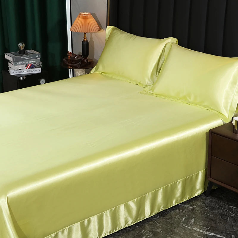 Lime green satin sheet set on a bed with a lamp and books in the background.