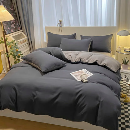 Gray bedding set on a bed in a bedroom with decor elements.