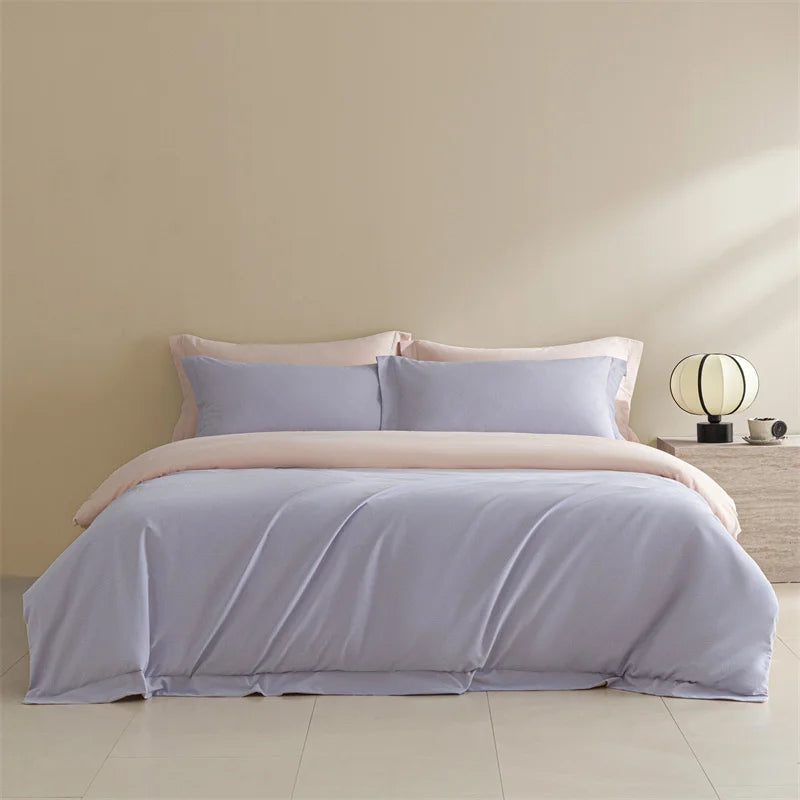Light purple bedding set on a bed in a minimalistic room.