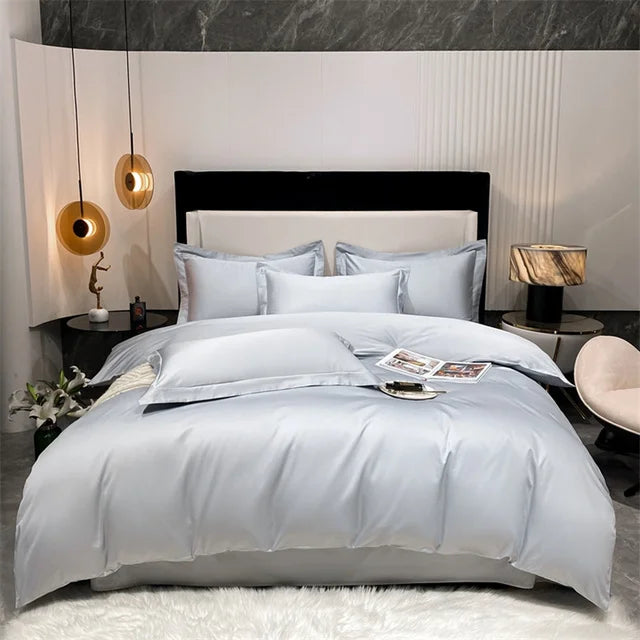 Neatly made bed with light blue bedding in a modern bedroom setting.
