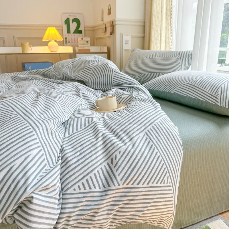Bed with striped bedding in a well-lit bedroom
