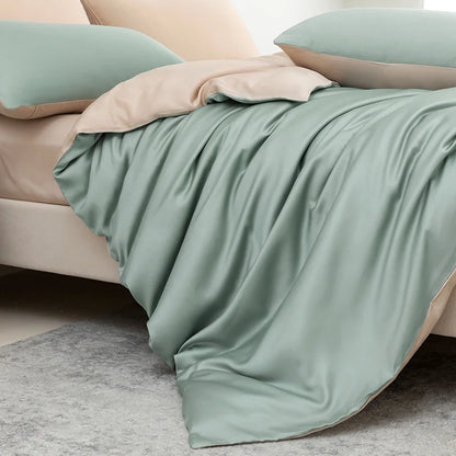 Green bedding set on a bed with a neutral headboard.