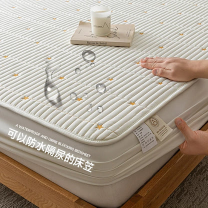 Mattress protector with text on a bed, showing waterproof feature.