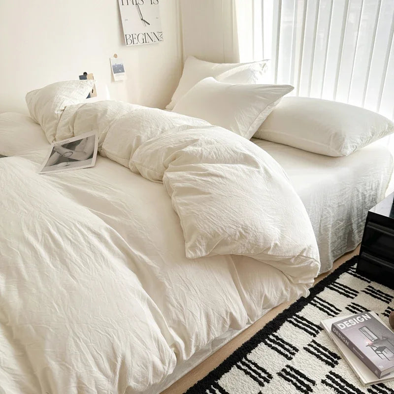 Neatly made bed with white bedding in a bright bedroom.