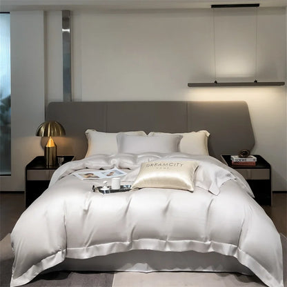 Modern bedroom with a bed featuring satin bedding, nightstands, and decorative items.