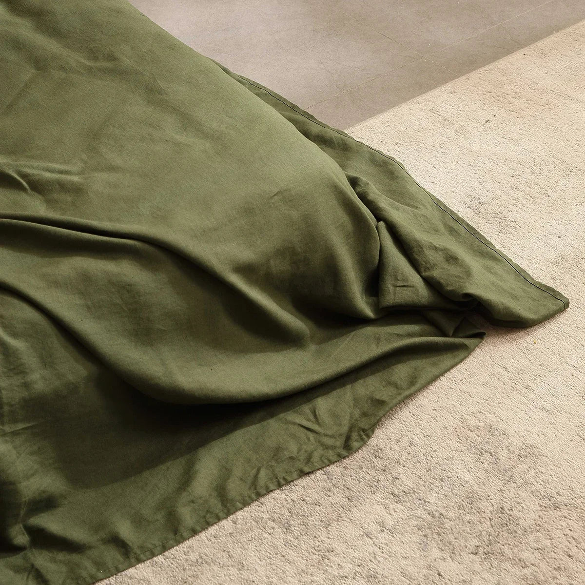 Green fabric draped over a textured surface