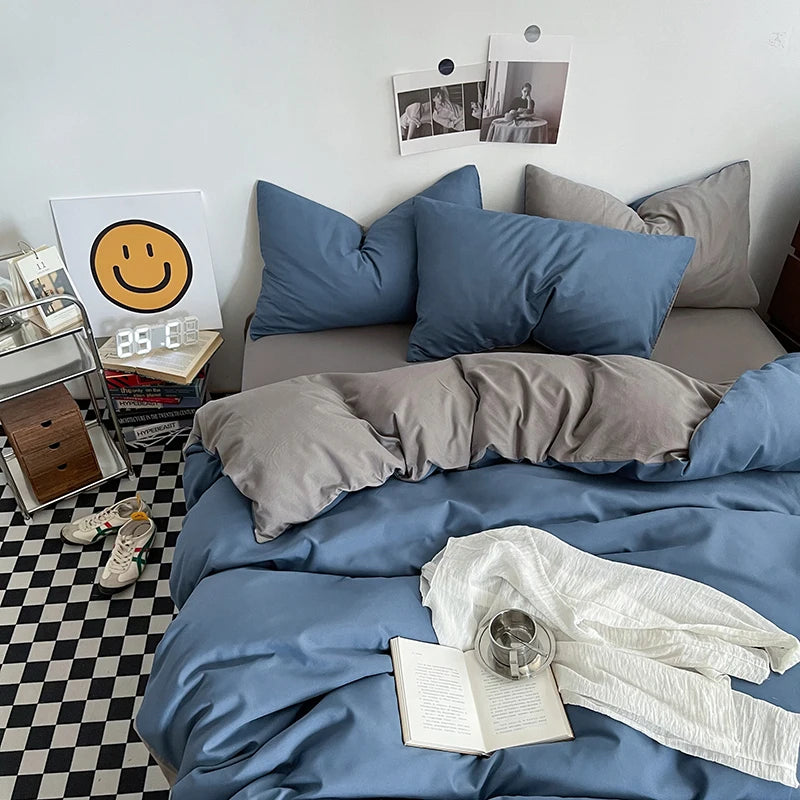 Bedroom with blue and gray bedding, a smiley face poster, and a checkered floor.