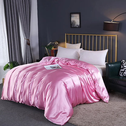 Bedroom with pink comforter on a bed against a dark wall.