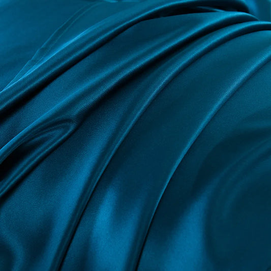 Close-up of blue satin fabric with folds