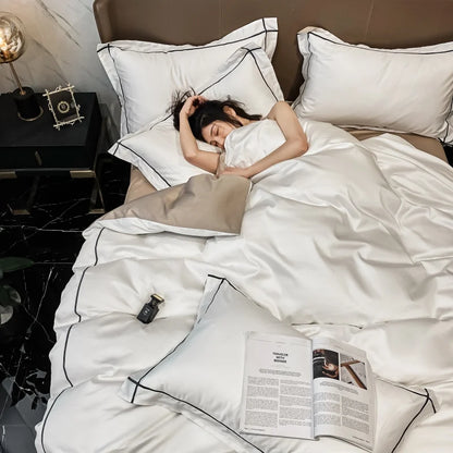 Woman sleeping on a bed with white bedding and an open magazine.