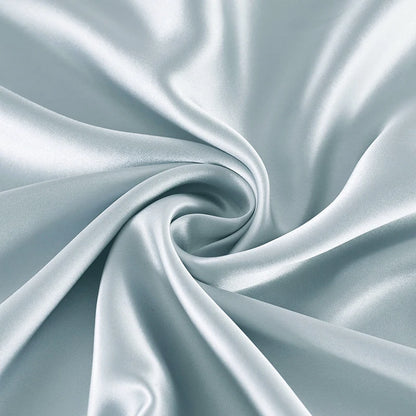 Close-up of light blue satin fabric with folds