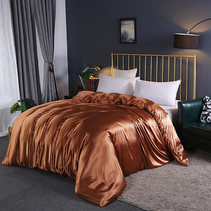 Bedroom with brown satin bedding and gold headboard