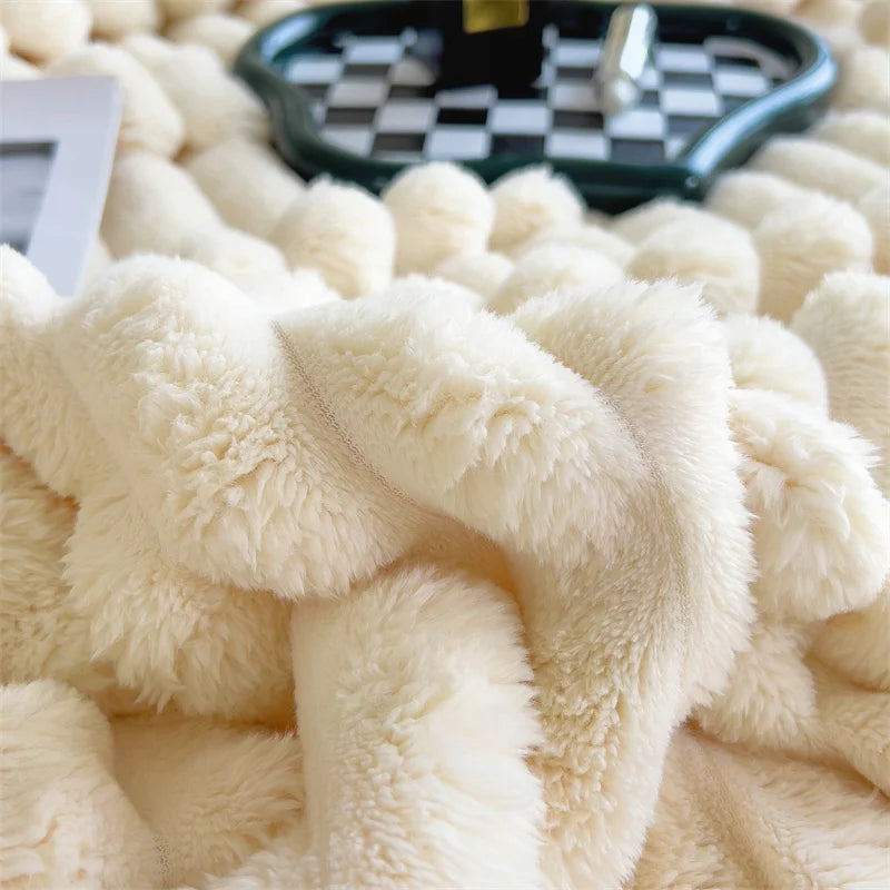Close-up of a fluffy beige blanket with a checkered tray in the background.