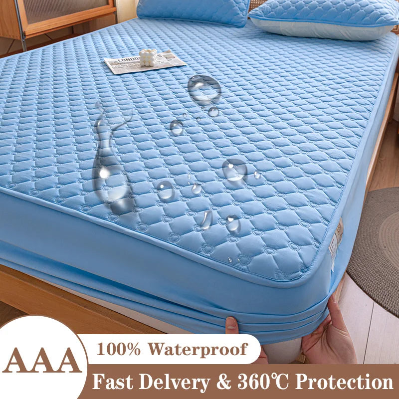 Blue mattress protector with water droplets on a bed, held by a hand.