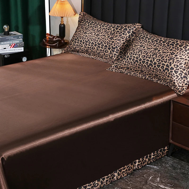 Bed with brown satin sheets and leopard print pillowcases in a bedroom setting.