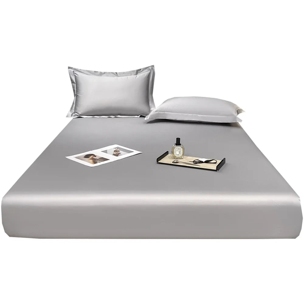 Gray satin sheet set with pillowcases on a white background