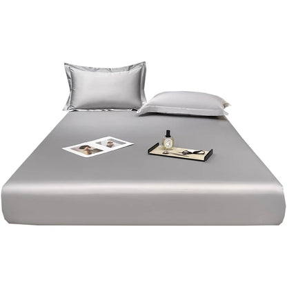 Gray satin sheet set with pillowcases on a white background