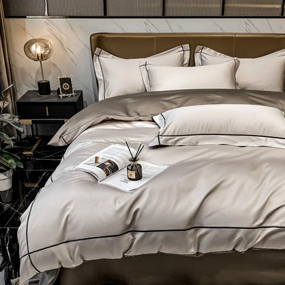 Neatly made bed with beige and white bedding in a modern bedroom setting.