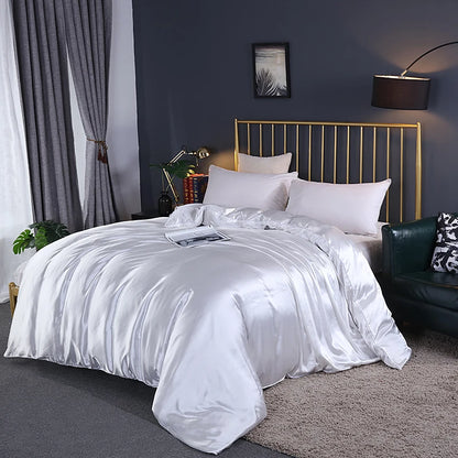 Bedroom with a bed covered in white satin bedding, gold headboard, and dark walls.